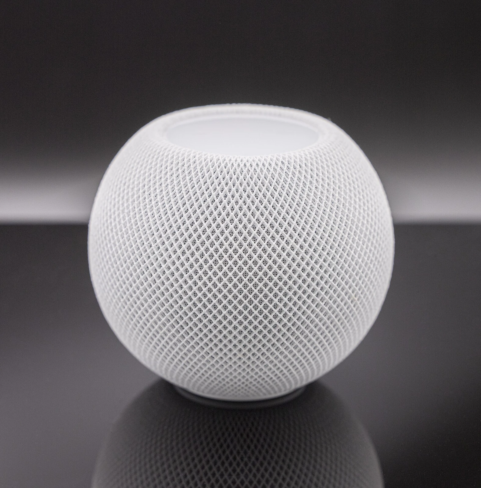 Original white HomePod mini, photographed in the studio.